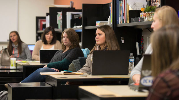 Students sit at individual desks with their computers in the interior design studio at La Roche University.